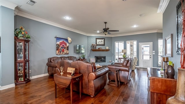 living area with a ceiling fan, visible vents, baseboards, ornamental molding, and dark wood-style floors