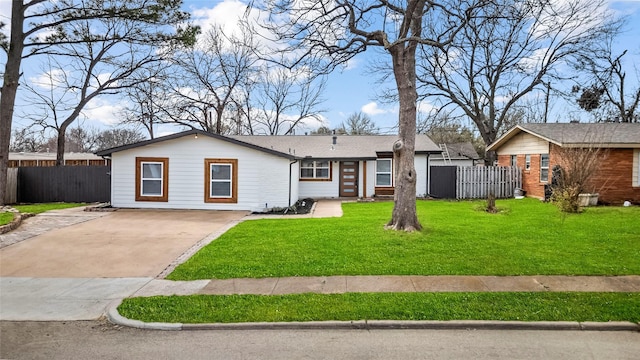 ranch-style house featuring concrete driveway, a front yard, and fence