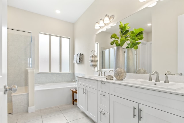 bathroom with tiled shower, a sink, a bath, and tile patterned floors