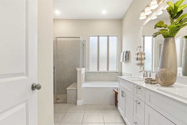 bathroom with a stall shower, tile patterned floors, a garden tub, and vanity