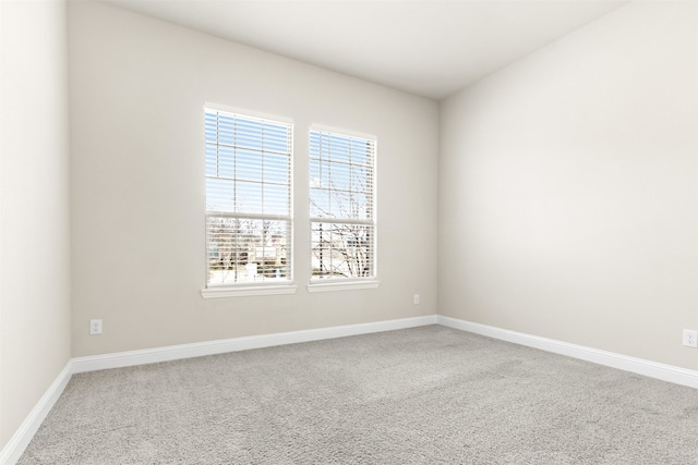 unfurnished room with carpet floors and baseboards