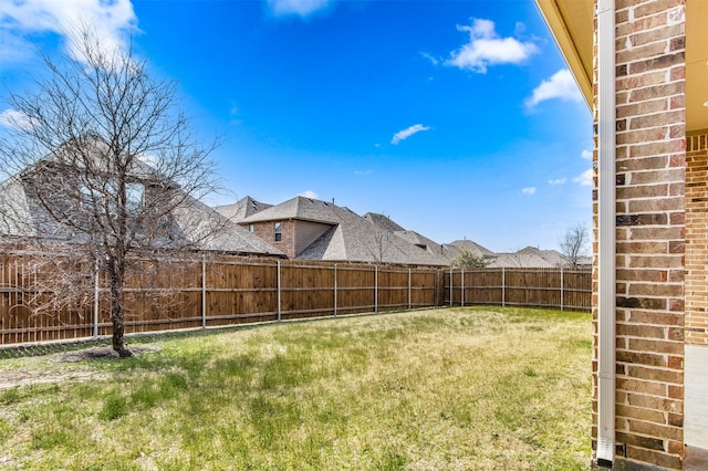 view of yard with a fenced backyard