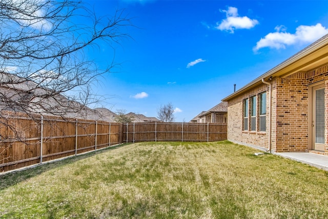 view of yard with a fenced backyard