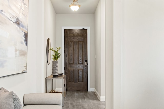 entryway featuring baseboards and wood finished floors