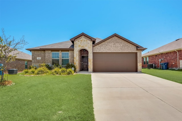 view of front of house with driveway, a garage, a front lawn, and central AC