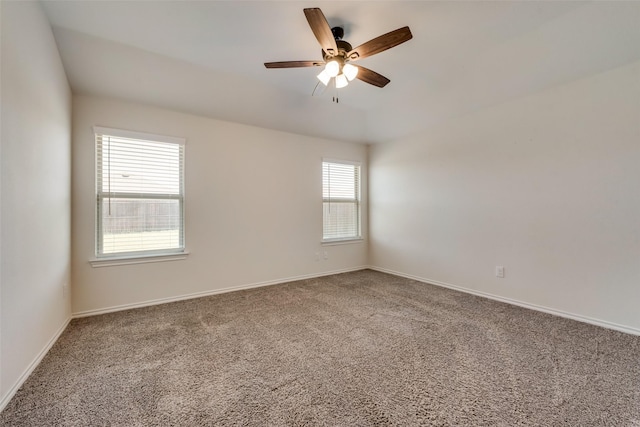 empty room featuring carpet, ceiling fan, and baseboards