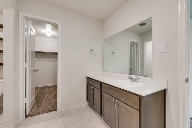 full bathroom with visible vents, a spacious closet, vanity, tile patterned flooring, and baseboards