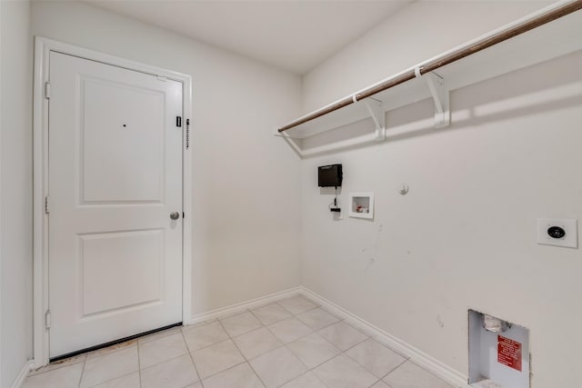 clothes washing area featuring hookup for a washing machine, gas dryer hookup, electric dryer hookup, laundry area, and baseboards