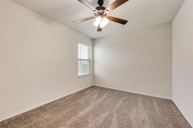 carpeted empty room with baseboards and a ceiling fan