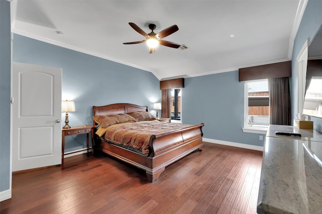 bedroom with ceiling fan, visible vents, baseboards, ornamental molding, and wood-type flooring