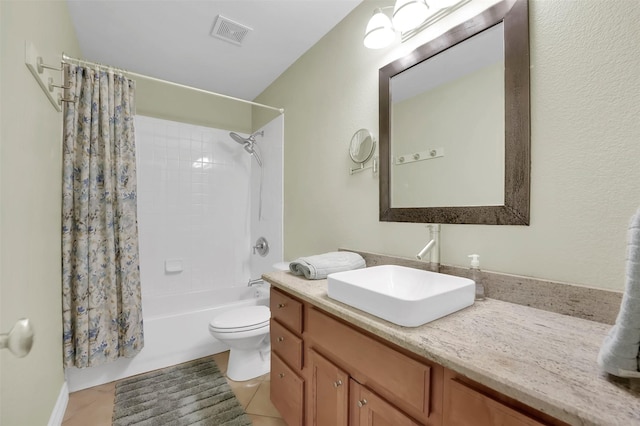 bathroom featuring toilet, vanity, visible vents, tile patterned floors, and shower / bath combo with shower curtain