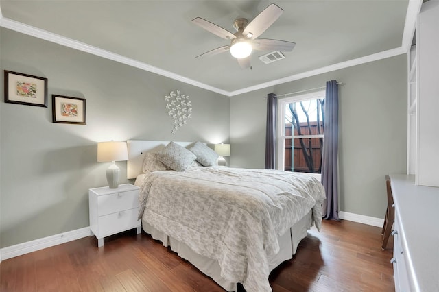 bedroom featuring dark wood-style floors, visible vents, crown molding, and baseboards