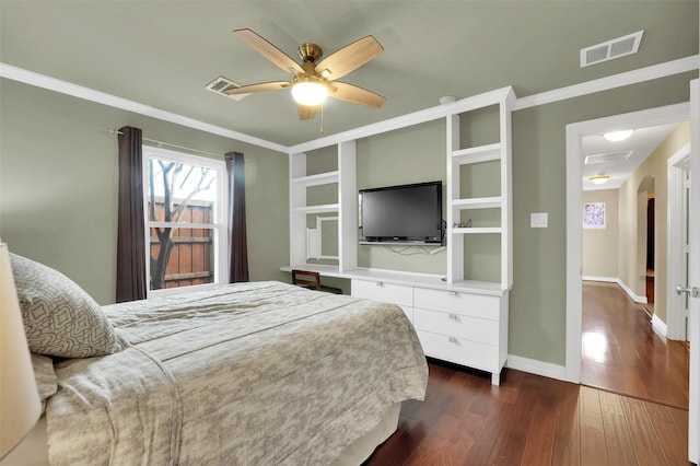 bedroom with ornamental molding, dark wood-style flooring, visible vents, and baseboards