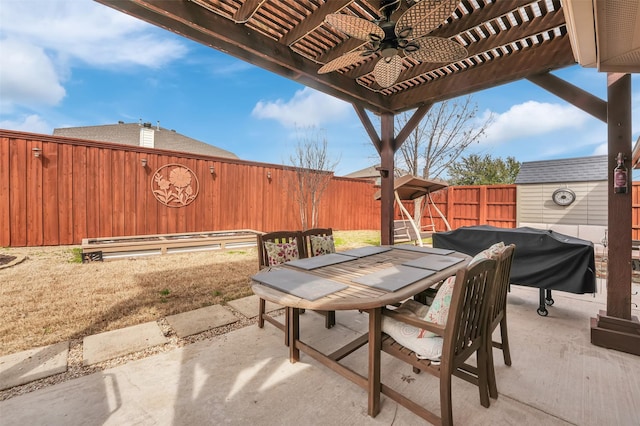 view of patio featuring outdoor dining area, grilling area, a fenced backyard, and a pergola