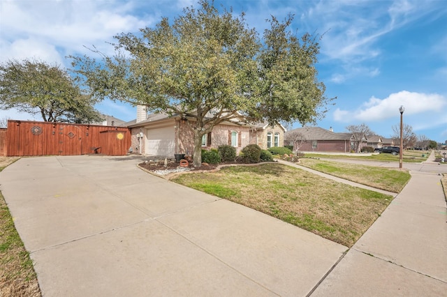 ranch-style home featuring a garage, concrete driveway, a chimney, a front yard, and brick siding