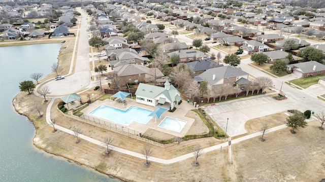 birds eye view of property with a water view and a residential view