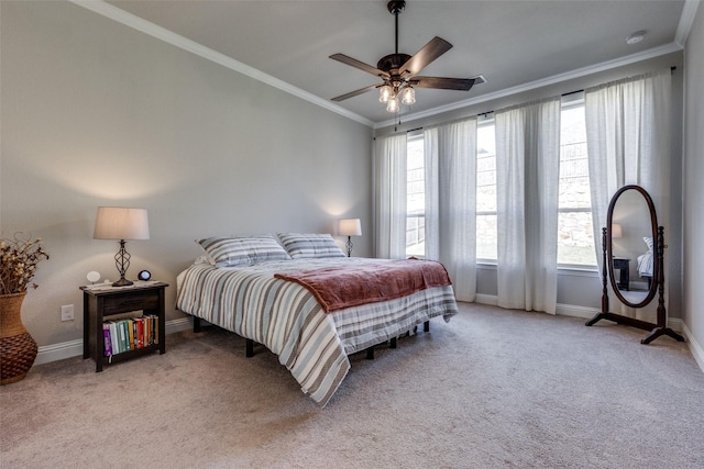 bedroom featuring baseboards, a ceiling fan, light colored carpet, and crown molding