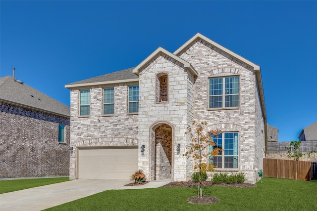 view of front of house with a garage, concrete driveway, fence, a front lawn, and brick siding