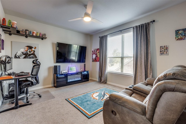 living area featuring a ceiling fan, carpet flooring, and baseboards