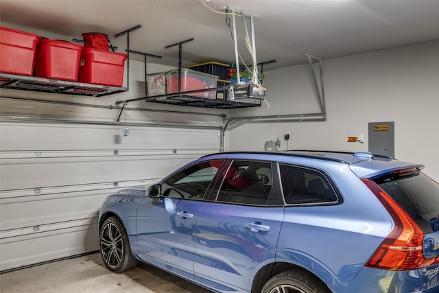 garage featuring a garage door opener and electric panel