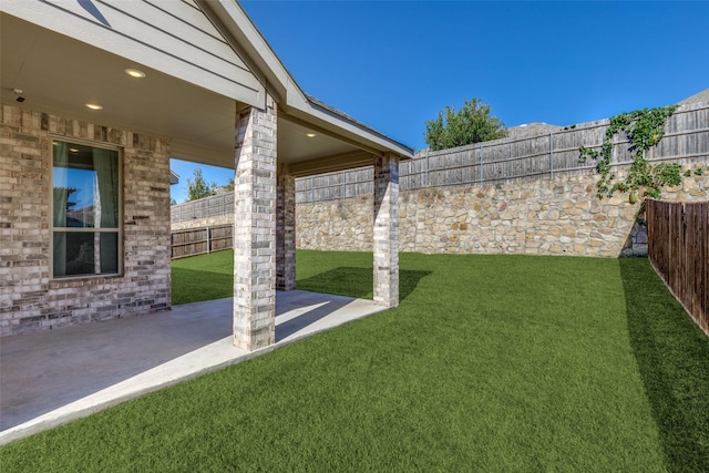 view of yard with a patio area and a fenced backyard