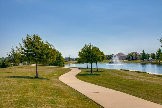 view of community featuring a water view and a lawn