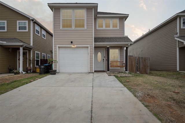 view of front facade featuring a garage, concrete driveway, roof with shingles, and fence