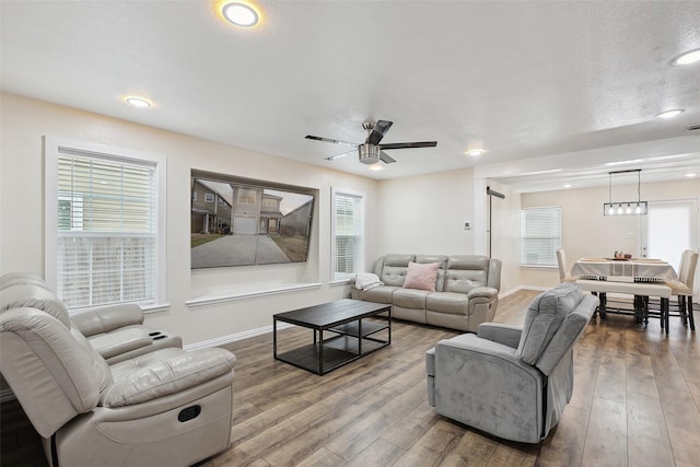 living room with recessed lighting, ceiling fan, baseboards, and wood finished floors