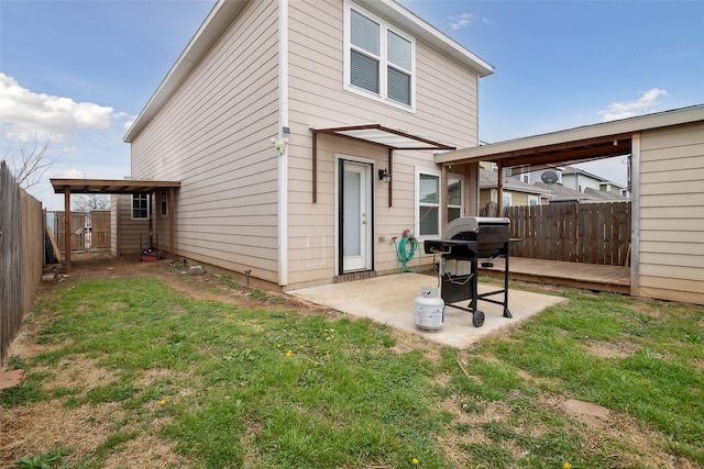 back of property with a patio area, a fenced backyard, and a lawn