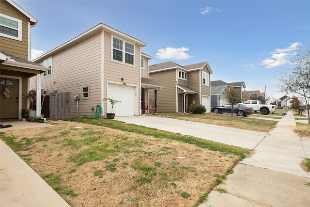 view of front facade with a residential view, concrete driveway, central AC, and an attached garage