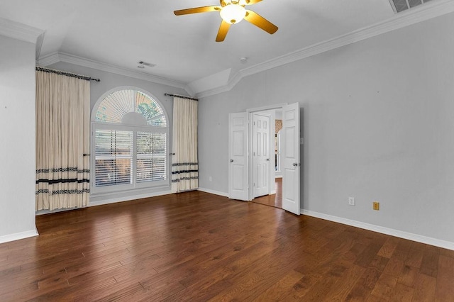 empty room with visible vents, crown molding, baseboards, and wood finished floors