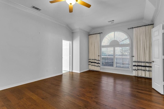 spare room with wood finished floors, visible vents, and crown molding