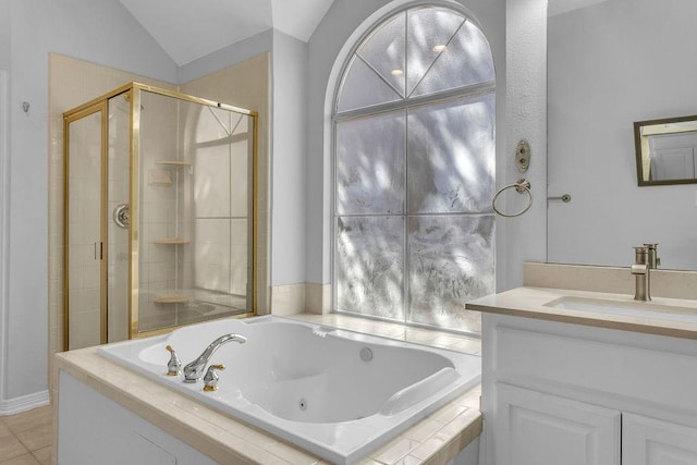 full bath featuring vanity, vaulted ceiling, a jetted tub, tile patterned floors, and a stall shower