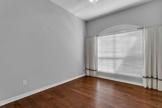 unfurnished room featuring wood finished floors, a ceiling fan, and baseboards