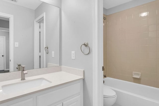 bathroom with visible vents,  shower combination, vanity, and toilet