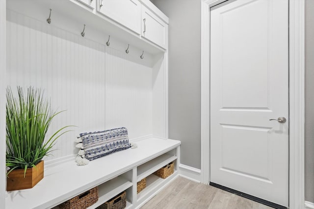 mudroom featuring light wood-style flooring and baseboards