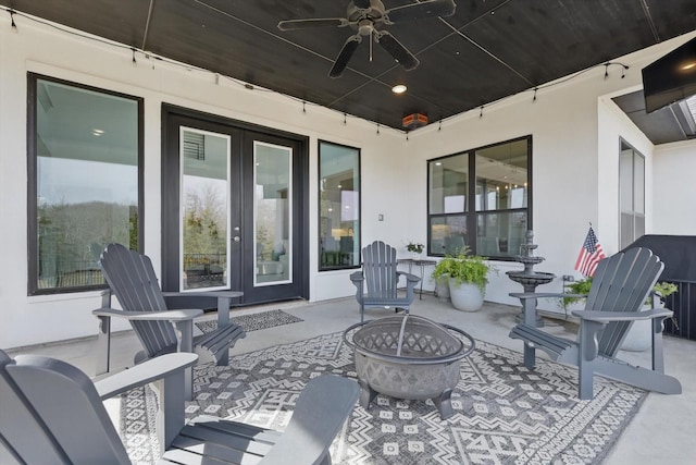 view of patio / terrace with a fire pit and a ceiling fan