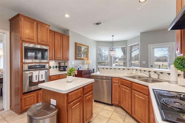 kitchen with light tile patterned floors, a sink, visible vents, light countertops, and appliances with stainless steel finishes