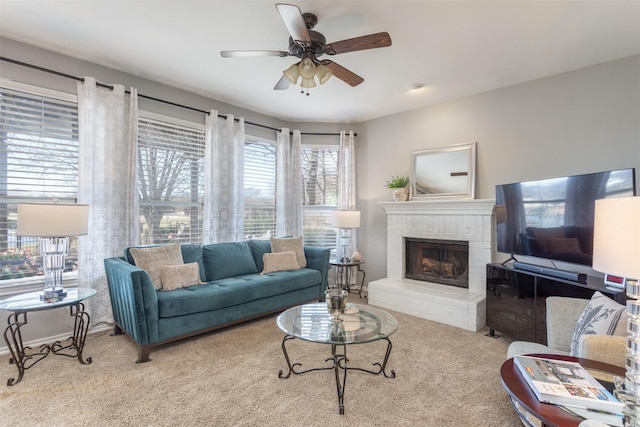 carpeted living room with a ceiling fan and a fireplace