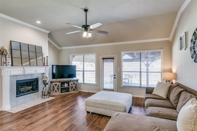 living room with vaulted ceiling, plenty of natural light, wood finished floors, and crown molding