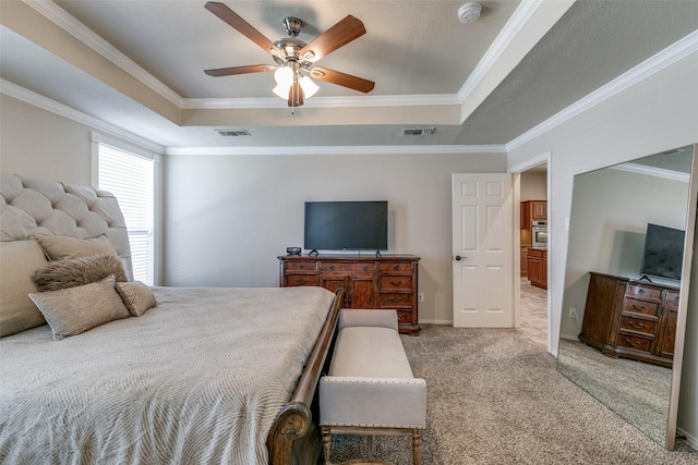 bedroom with a raised ceiling, visible vents, crown molding, and light carpet