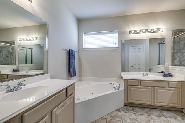 full bath featuring a stall shower, tile patterned flooring, a sink, and a jetted tub