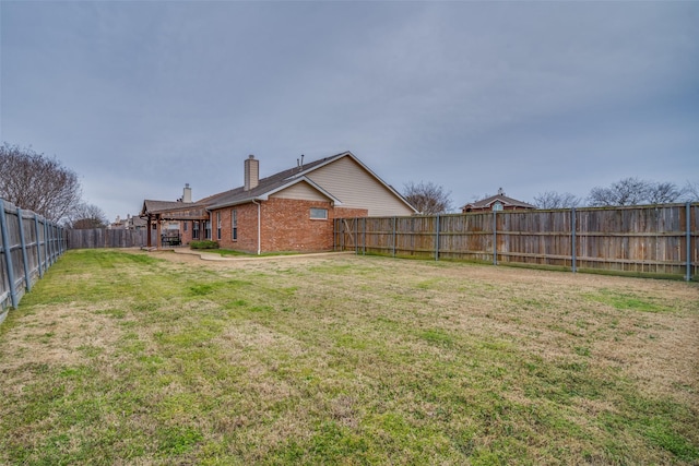 view of yard with a fenced backyard