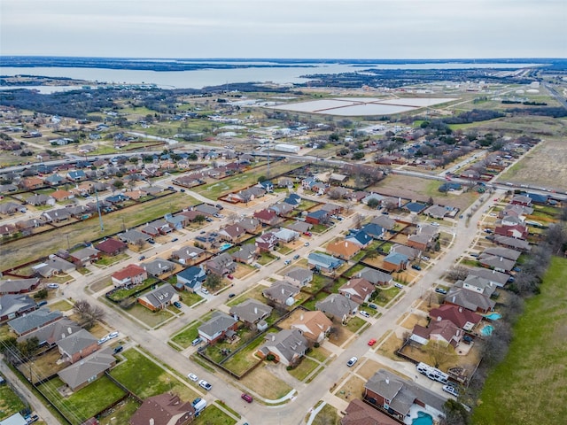 birds eye view of property with a water view and a residential view