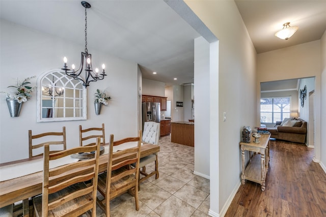 dining room featuring baseboards and an inviting chandelier