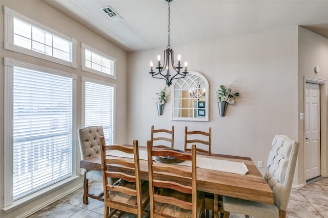 dining space featuring a chandelier, visible vents, and light tile patterned flooring