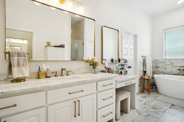 full bath featuring tile walls, a stall shower, a freestanding tub, marble finish floor, and vanity