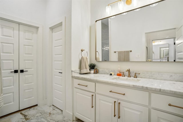 bathroom with vanity and marble finish floor