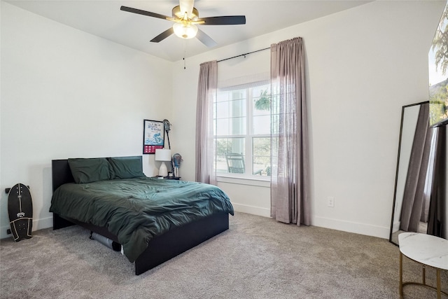 carpeted bedroom featuring baseboards and ceiling fan