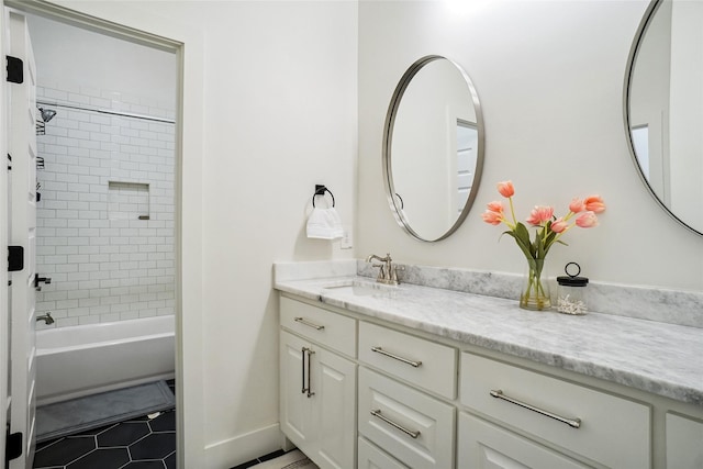 full bath featuring tub / shower combination, baseboards, vanity, and tile patterned flooring